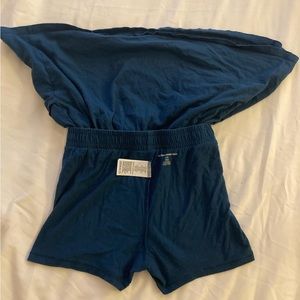 Skirt with built in shorts, navy blue, two pockets on side, and white drawstring